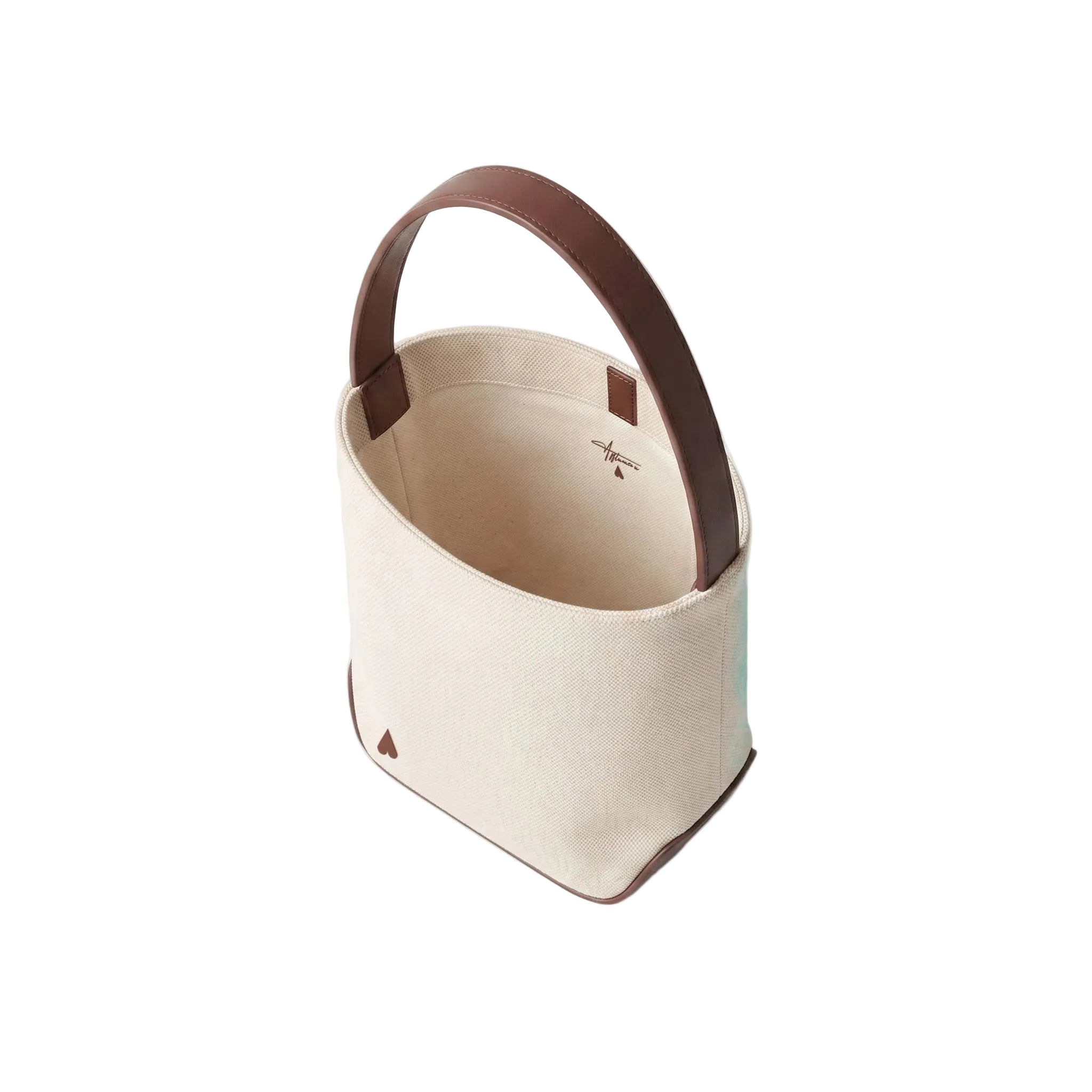 A canvas bucket bag in cream with dark brown leather trim and handle, shown from an elevated angle on a white background.