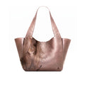 A Bronze leather hobo tote bag featuring a printed portrait of a woman with long brown hair on the front, set against a plain white background.