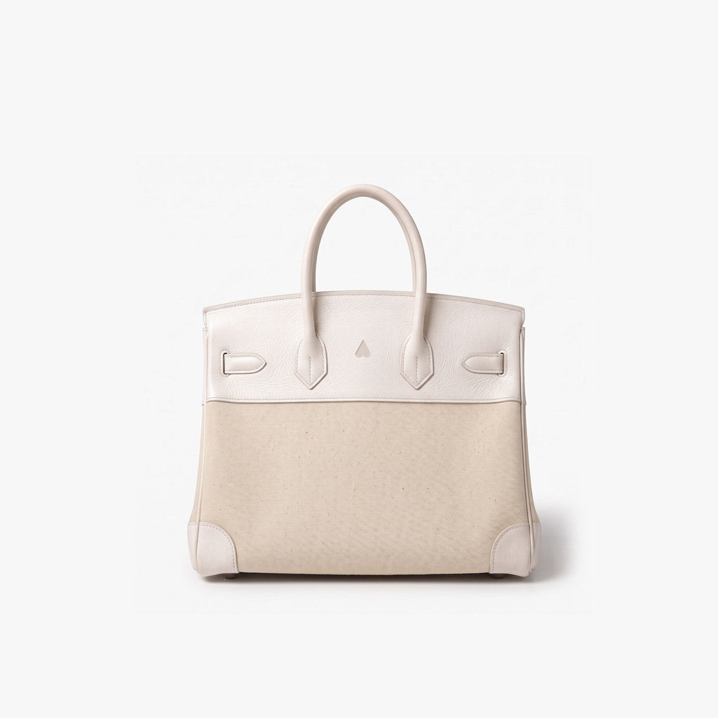 A structured leather handbag with a two-tone color-blocked design, featuring a light cream top section and handles, and a textured beige lower body, set against a plain white background.