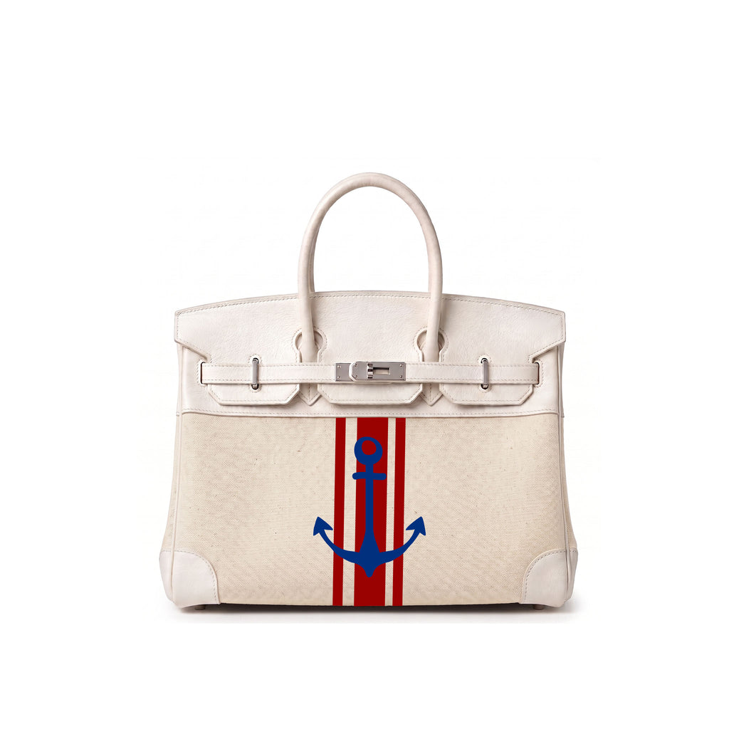 A structured cream-colored leather handbag with silver hardware, featuring a vertical red and white stripe design on the front with a blue anchor motif in the center.
