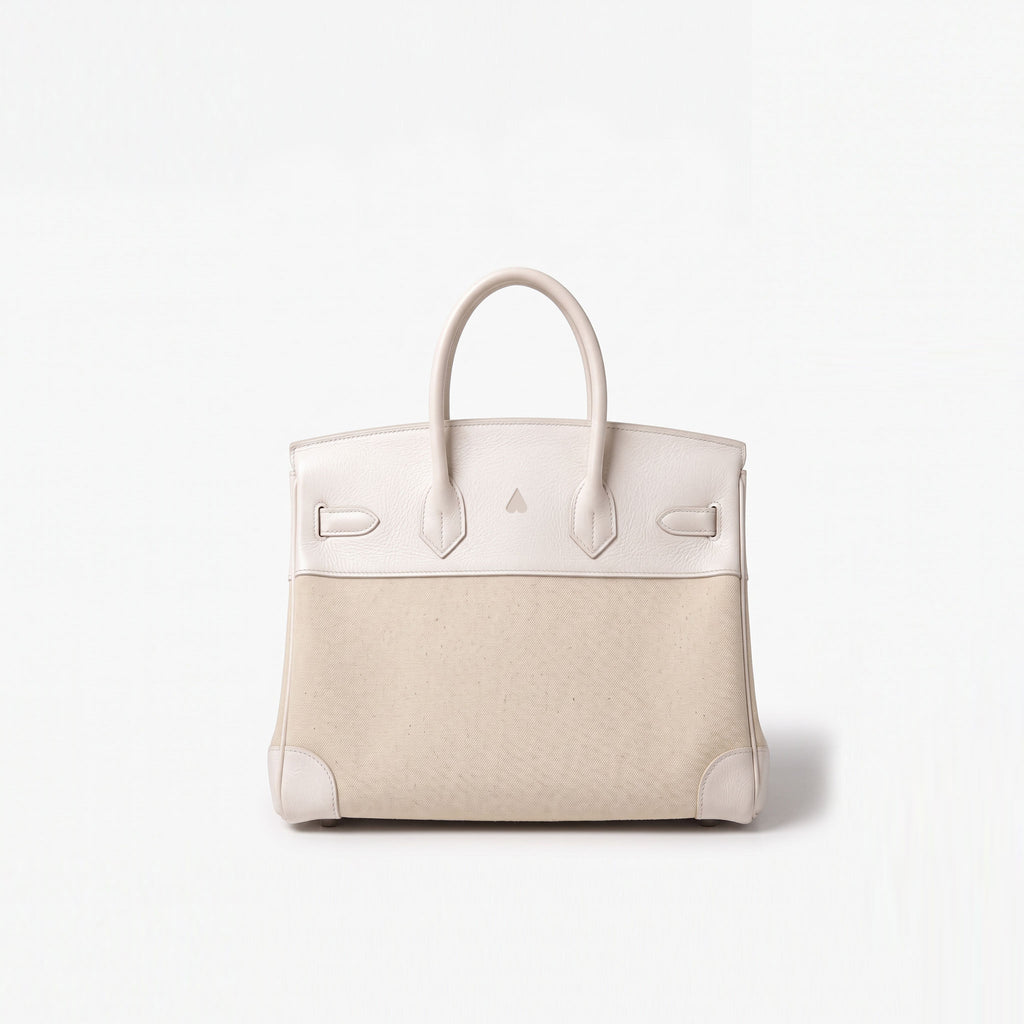 A structured leather handbag with a two-tone color-blocked design, featuring a light cream top section and handles, and a textured beige lower body, set against a plain white background.