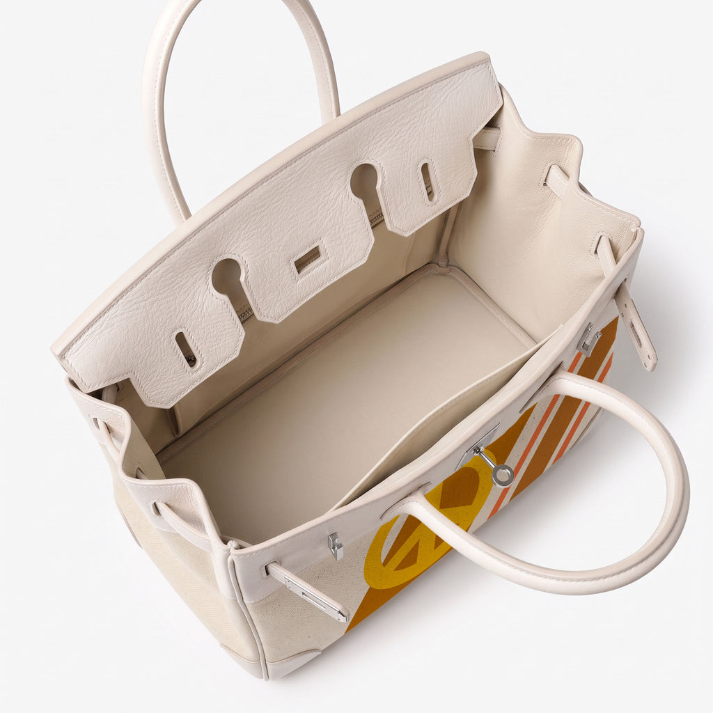 An open cream-colored leather handbag with structured handles and a yellow-and-white striped patterned insert or lining visible inside, photographed on a clean white background.