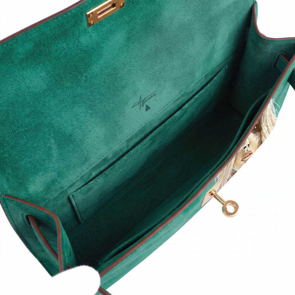 Crafted from luxurious green calfskin suede, the Kali Long clutch pochette combines a soft, velvety texture. Designed with a refined top handle, slim closure straps, and polished gold-tone twist-lock hardware, with front gorgeous art print, interior is green suede with inside pocket
