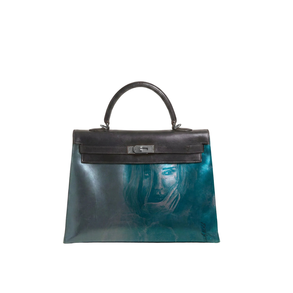 A structured leather handbag with a glossy teal and blue marbled finish, a black top handle and flap, and a silver-tone turn-lock clasp, featuring a faint artistic portrait printed on the front.