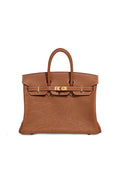A brown leather handbag with an embossed floral pattern on the lower front and gold-tone hardware, shown against a plain white background.