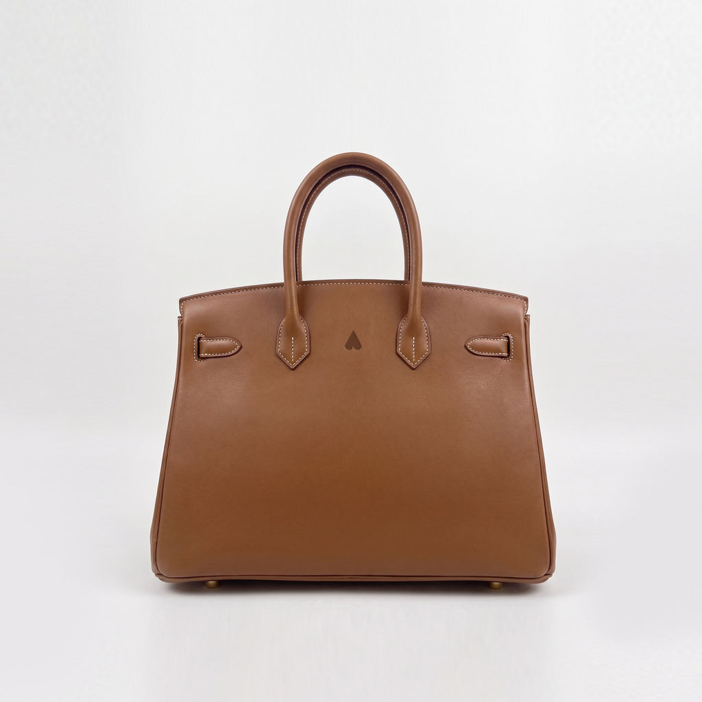 A classic brown leather handbag with double top handles, shown from the front against a clean white background.