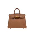 A brown leather handbag with an embossed floral pattern on the lower front and gold-tone hardware, shown against a plain white background.
