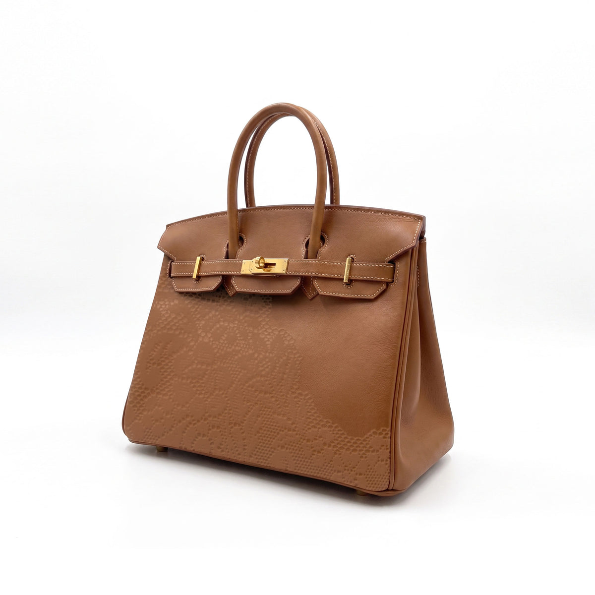 A brown leather handbag with an embossed floral pattern on the lower front and gold-tone hardware, shown against a plain white background.