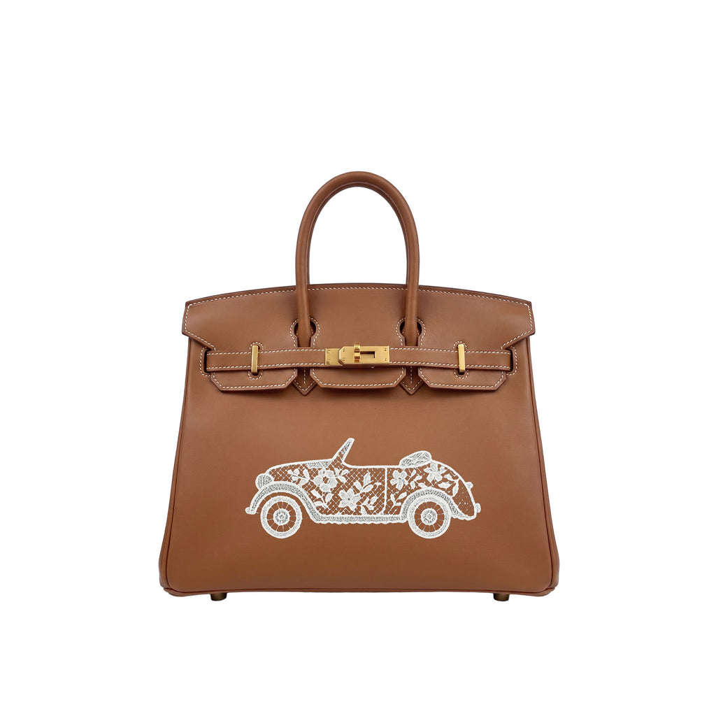 A brown leather handbag with gold-tone hardware and a white embroidered vintage car motif on the front, shown against a plain white background.