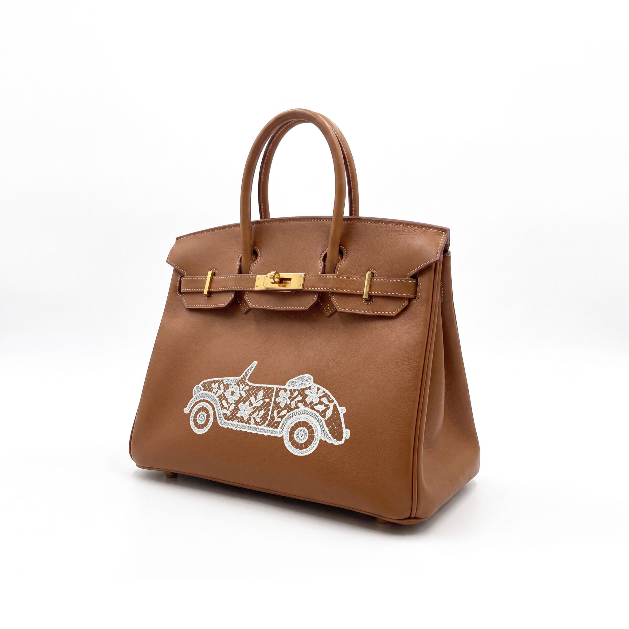 A brown leather handbag with gold-tone hardware and a white embroidered convertible car design on the front, photographed on a clean white background.