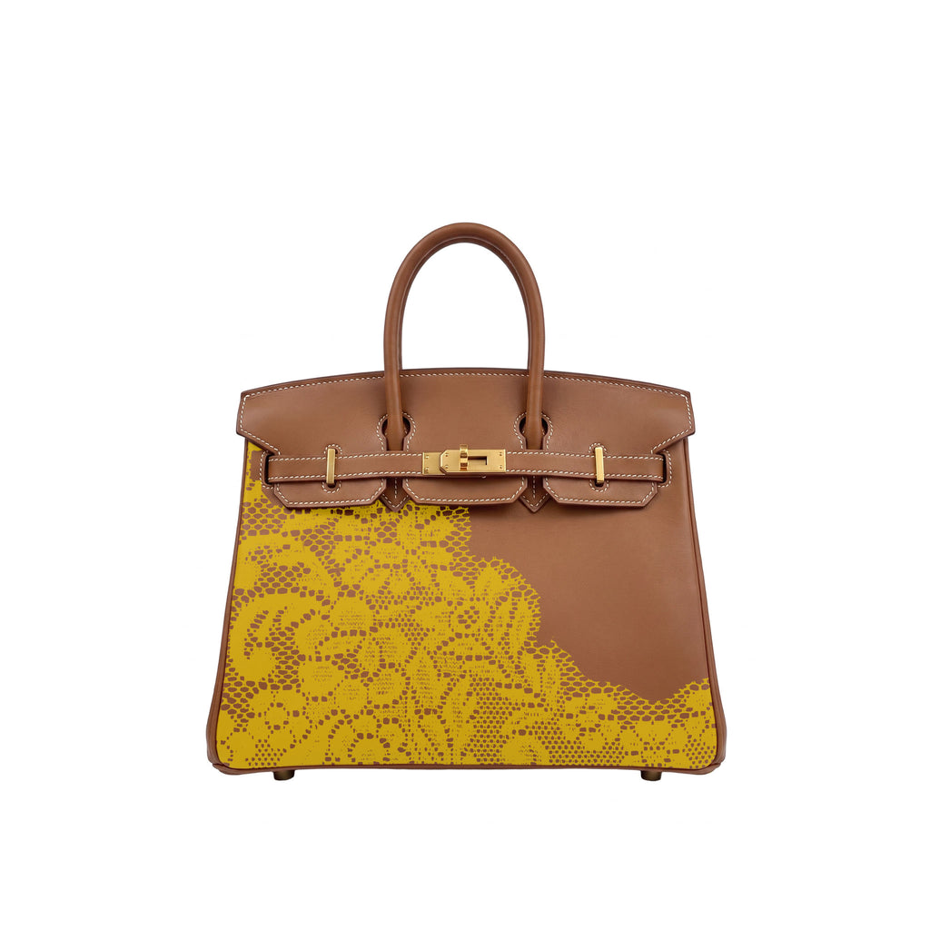 A structured brown leather handbag with a bright yellow floral print patterned lower panel and gold-tone hardware, photographed against a plain white background.