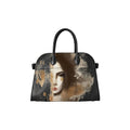 A structured black handbag with a curved dome shape, featuring a printed artistic portrait of a woman's face in muted beige, brown, and gray tones on the front. The bag has black double top handles and is photographed against a clean, off-white background.
