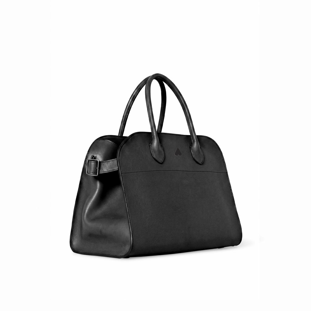 A black leather handbag with double top handles and a side buckle strap, photographed on a clean white background.