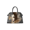 A structured grey leather handbag with a unique artistic print featuring a stylized woman's face in sepia tones over a textured, distressed background. The bag has two grey top handles and is shown against a plain white background.