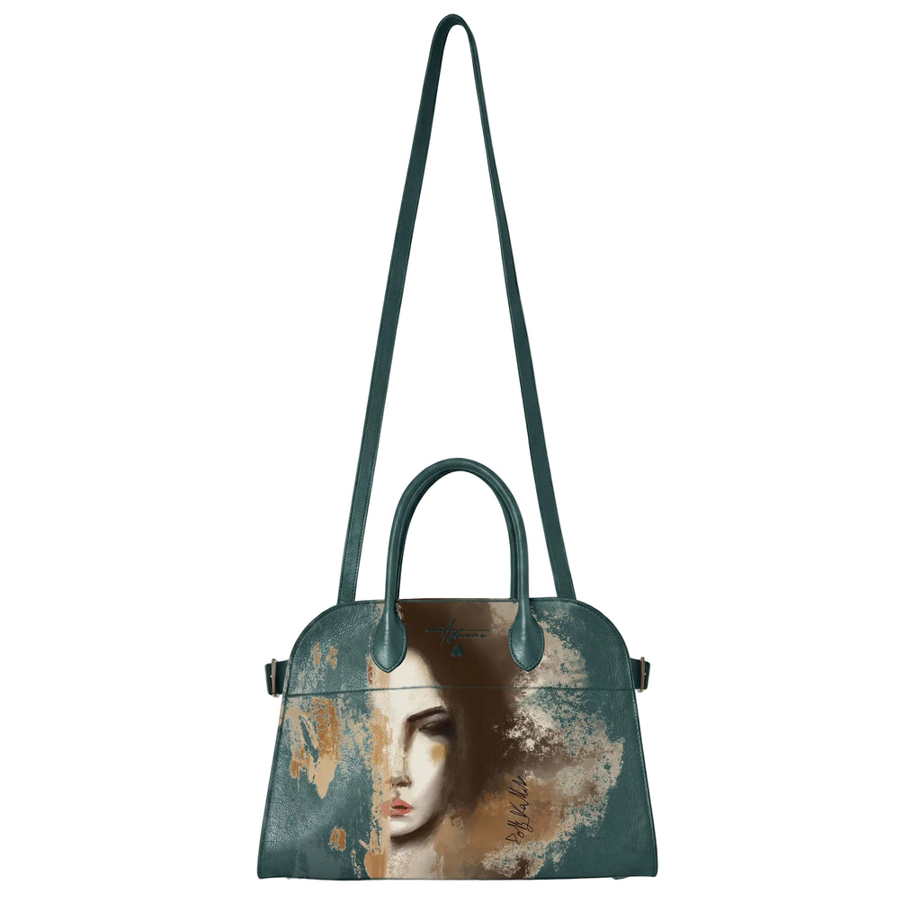 A structured dome handbag with a dark teal leather body and a long shoulder strap, featuring a printed artistic portrait of a woman on the front with distressed beige and brown paint textures.