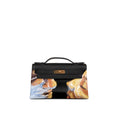 A structured black leather handbag with a top handle and gold-tone hardware, featuring a painted artistic print of two faces on the lower front panel, shown against a plain white background.