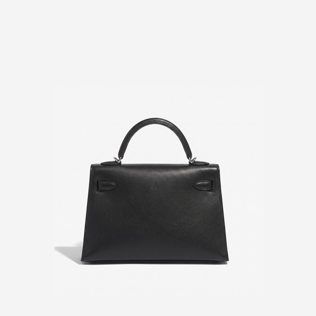 A structured black leather handbag with a top handle and silver-tone hardware, photographed against a clean white background.