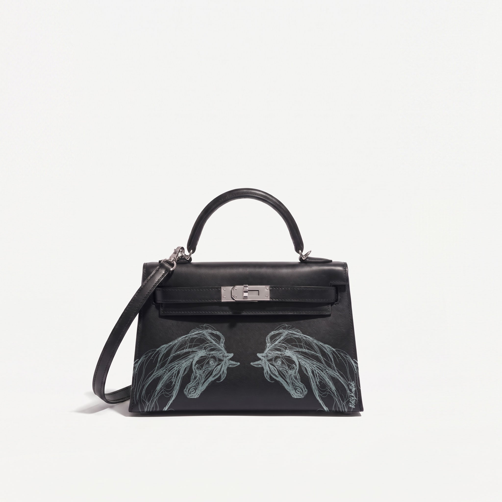 A black leather top-handle handbag with silver hardware and a shoulder strap, featuring two large Silver horse head illustrations on the lower front, photographed against a plain white background.