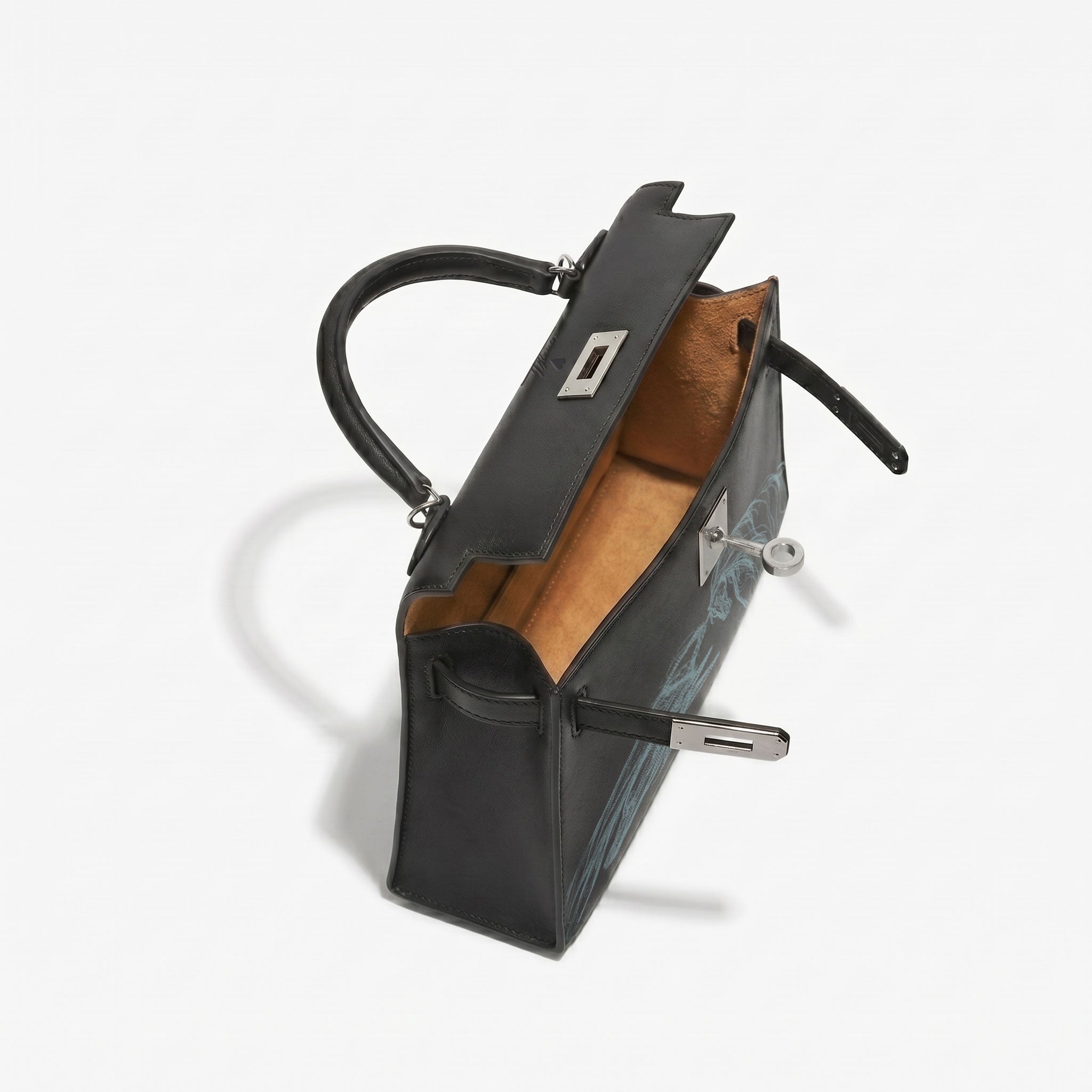 A black leather handbag with a structured rectangular silhouette, a top handle, silver-tone hardware, and a light brown interior, photographed on a clean white background.