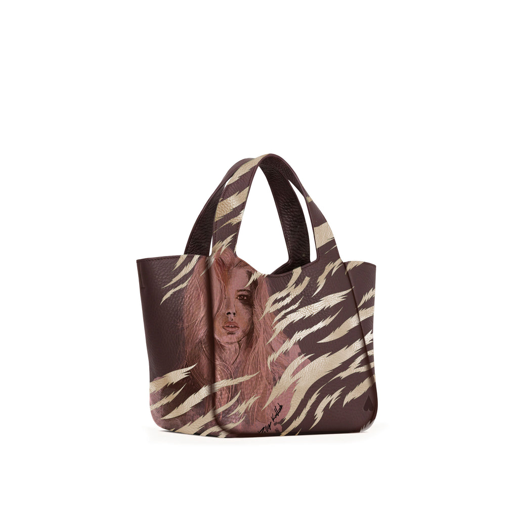 Eve Gold Zebra Handbag is crafted from supple deerskin leather with a naturally grainy finish and distinguished by a gorgeous artistic front print