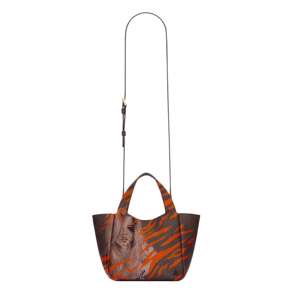 he Eve Orange Zebra Handbag is crafted from supple deerskin leather with a naturally grainy finish and distinguished by a gorgeous artistic front print with shoulder strap