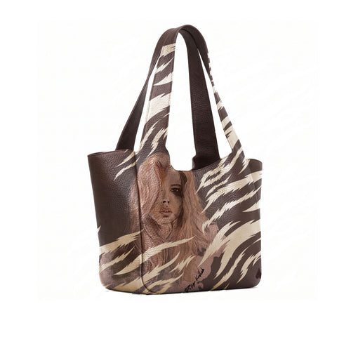 A brown full grained and gold zebra-print tote bag featuring a printed portrait of a woman on the front, set against a plain white background.